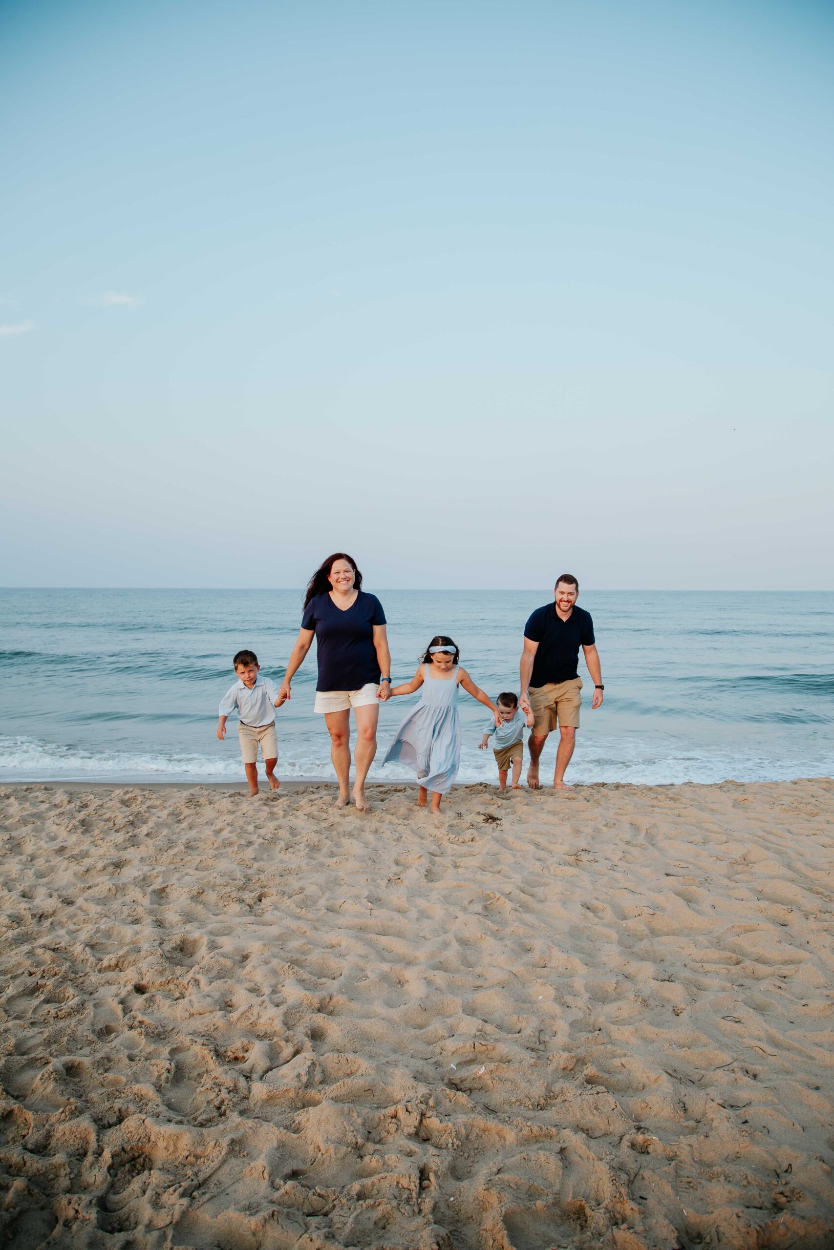 The Burge family walking on the beach at Sandbridge, Virginia